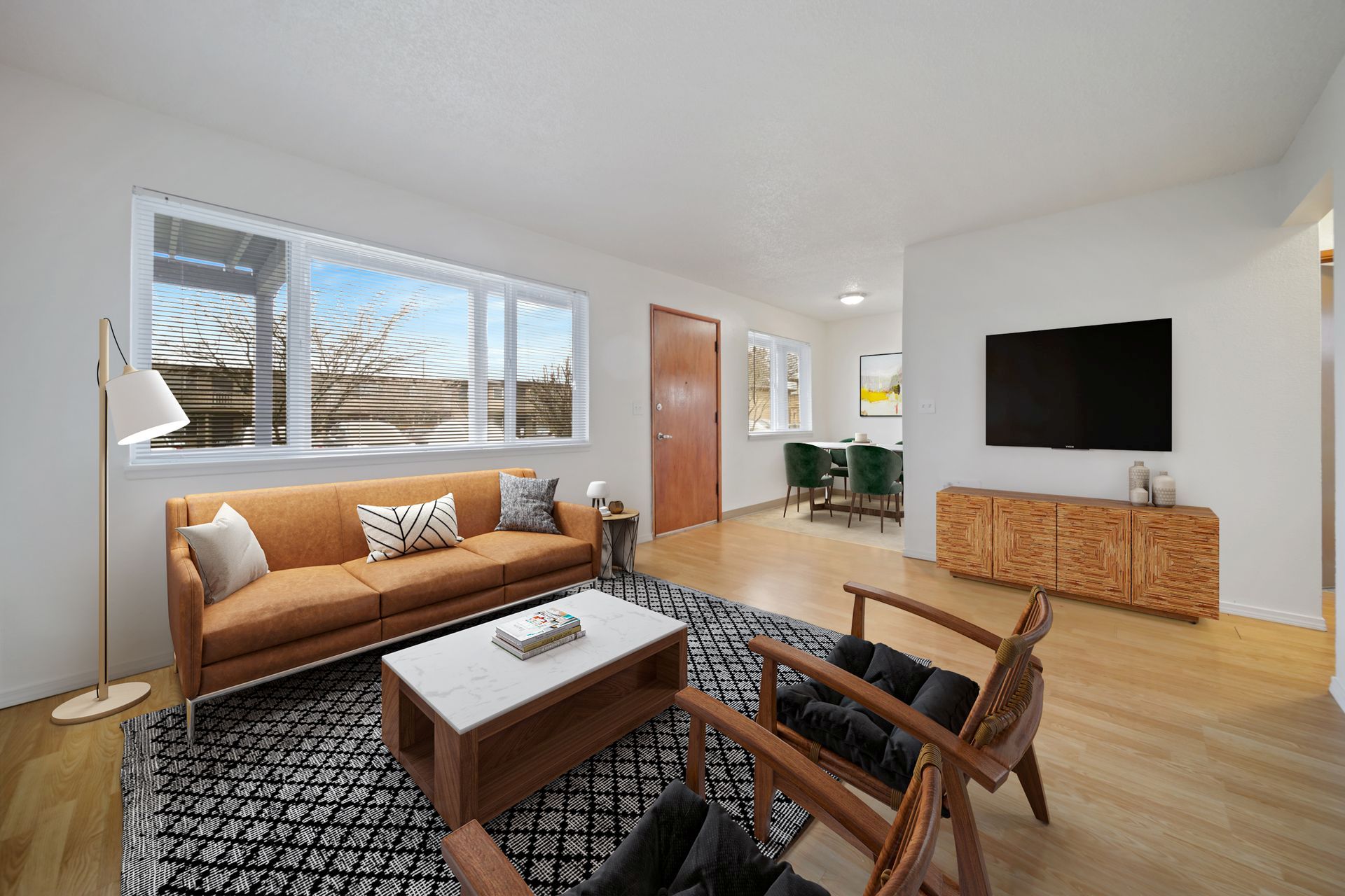 Living room with large windows in a Cherry Tree apartment home